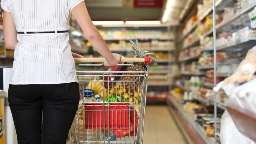 donna al supermercato con carrello della spesa